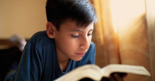 เด็กหนุ่มกำลังอ่านพระคัมภีร์