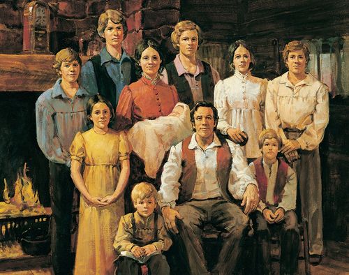 A painting depicting the Joseph family in the family log home with father Smith seated in the middle and Joseph standing behind, near the fireplace.