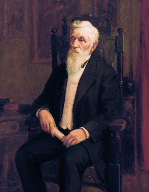 A portrait by Lewis A. Ramsey of President Lorenzo Snow in a black suit, sitting in a wooden chair and holding a rolled-up piece of paper.