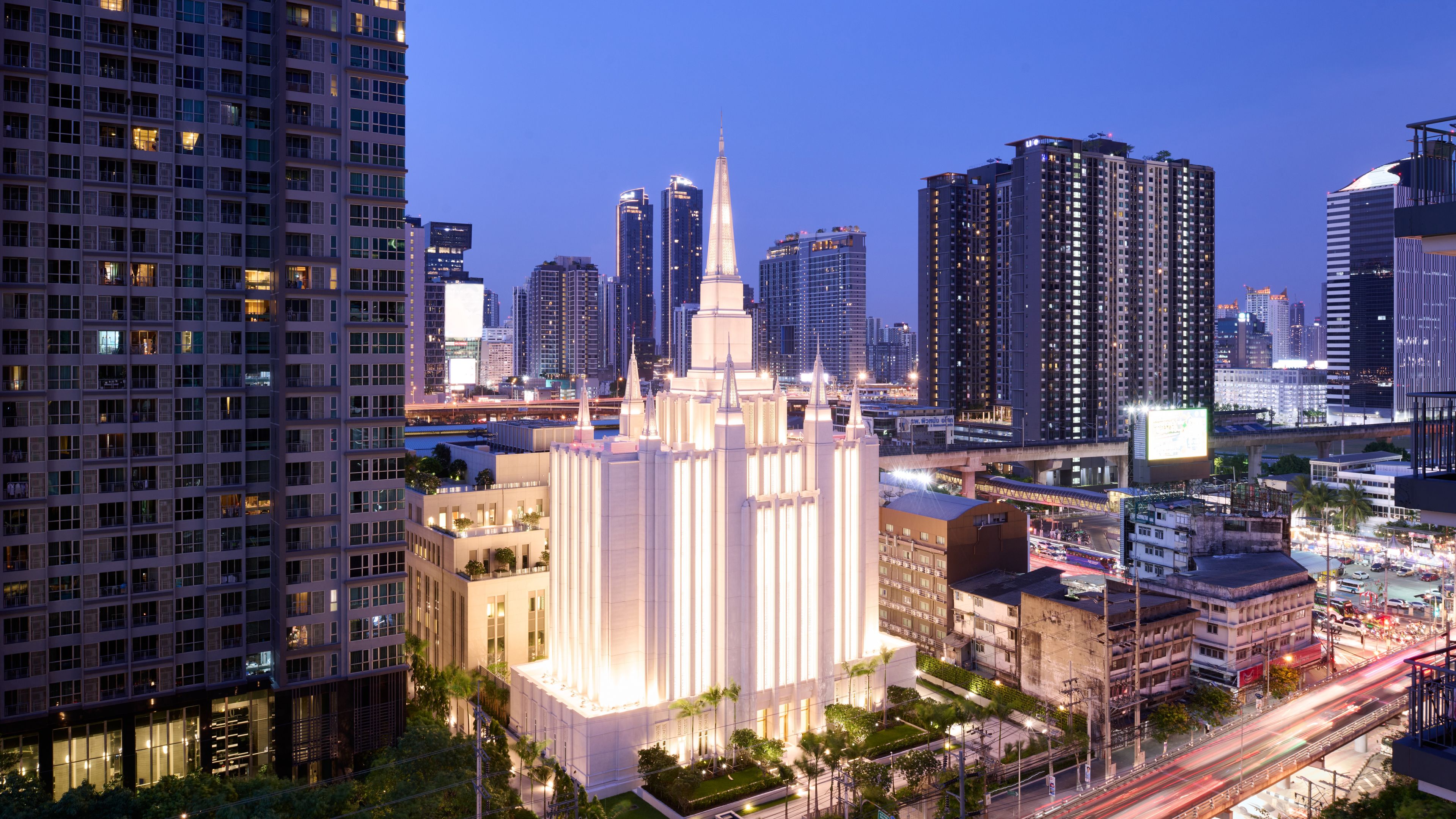 Images of the exterior of the Bangkok Thailand Temple. Images feature the architectural detail of the temple taken from a distance so you see the temple and the surrounding skyscrapers. 