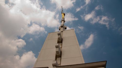 The angel Moroni statue is seen from a low angle atop the spire of the Mexico City Mexico Temple.
