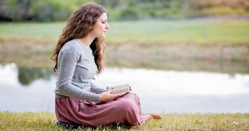 young woman ponders scriptures