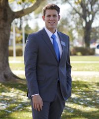 A missionary models appropriate clothing. He wears correct and approved suits and ties.