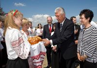 Lada and Kateryna Serdiuk present a special Ukrainian bread to President Dieter F. Uchtdorf and Sister Harriet Uchtdorf at the Kyiv Ukraine Temple site.