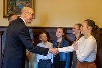 President Henry B. Eyring greeting youth you attend Senate session.