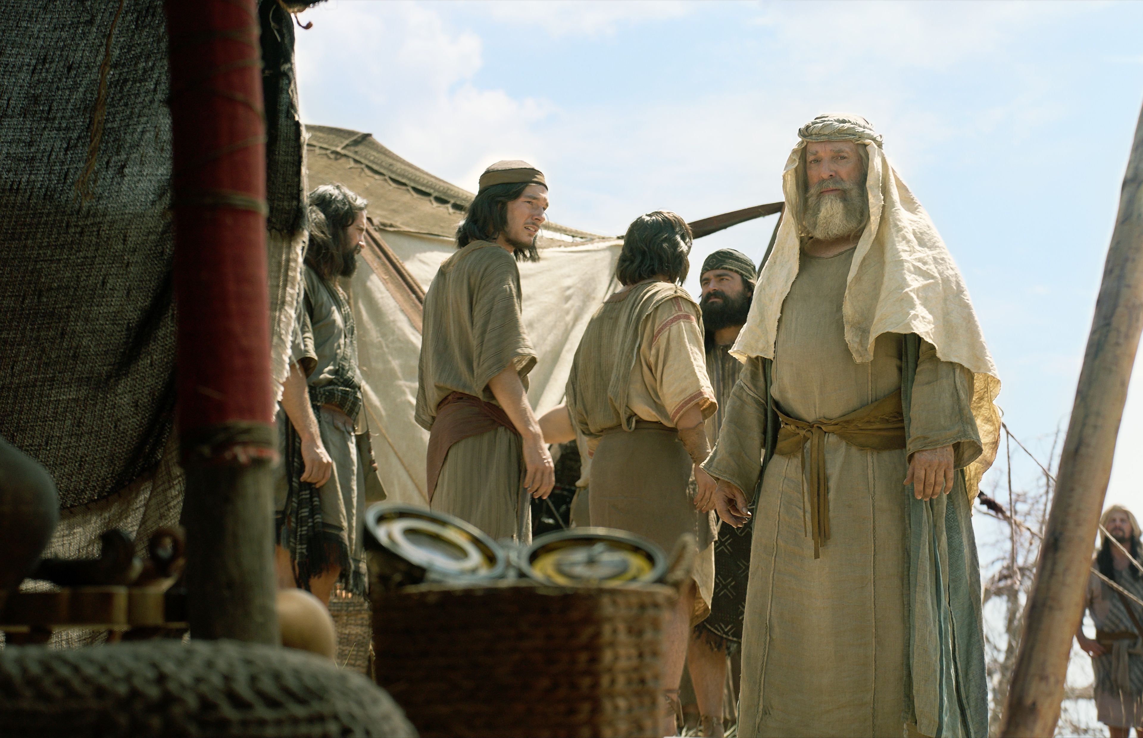 Lehi looks at the Liahona as his family argues over the broken bow.