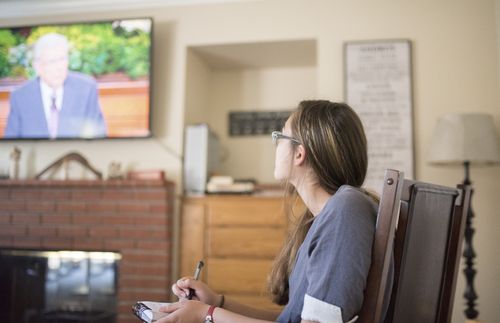 young woman watching general conference