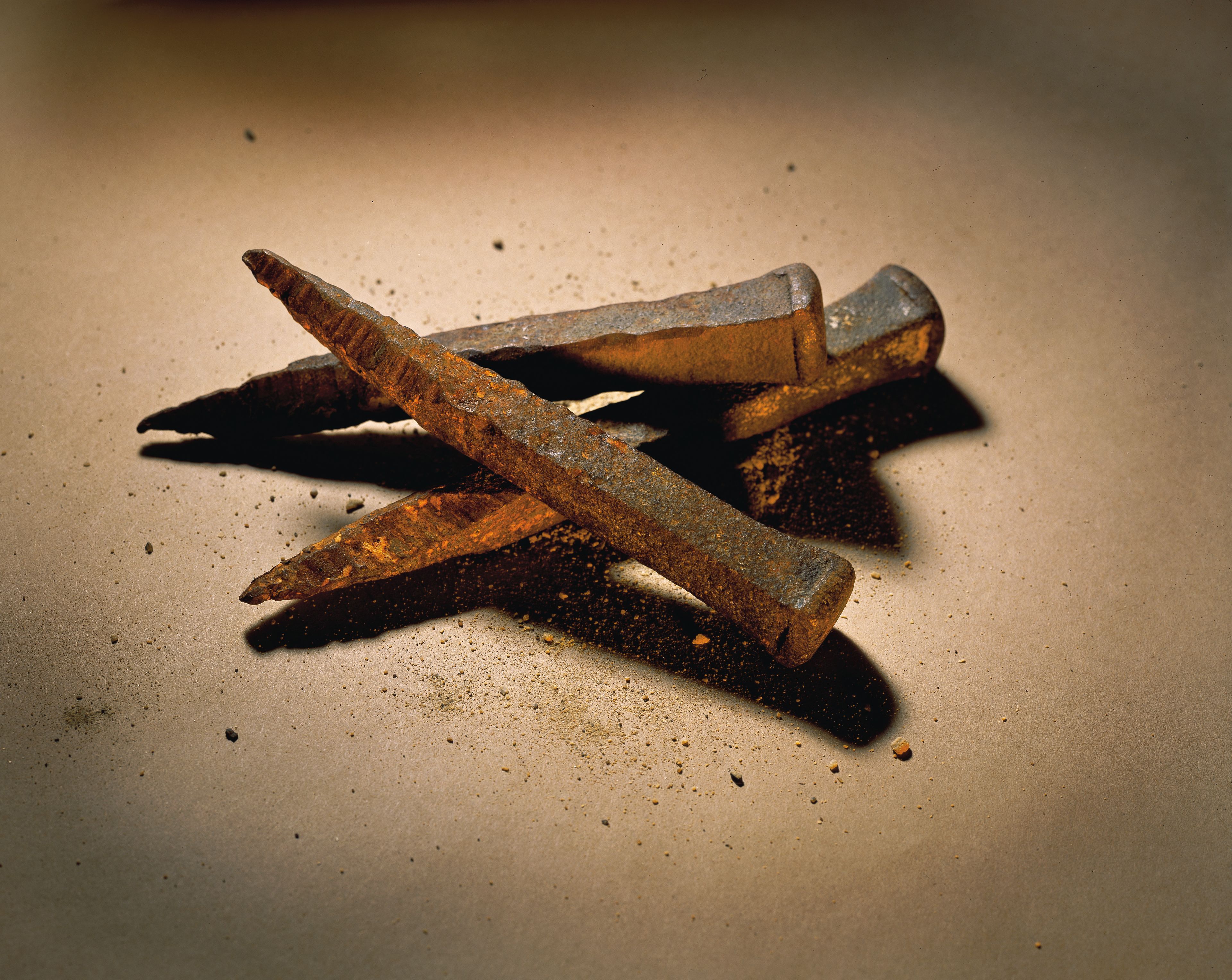 A set of three rusted crucifixion nails.