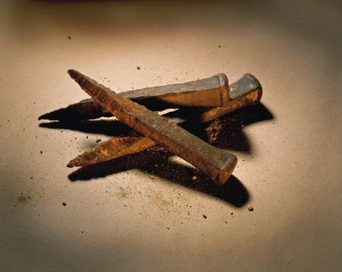 Three old rusted iron nails of the type that would have been used to crucify Christ.