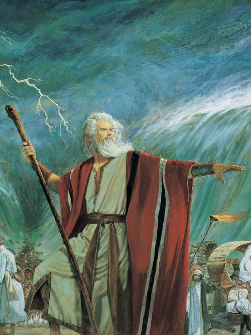 The Old Testament prophet Moses standing with his arm extended toward the Red Sea. Moses is commanding the Red Sea to part to allow the Israelites to escape the Pharoah of Egypt.