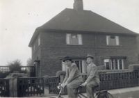 Elder M. Russell Ballard with his mission companion Elder Thackery riding a tandem bike, while serving in the British Mission from 1948 to 1950.