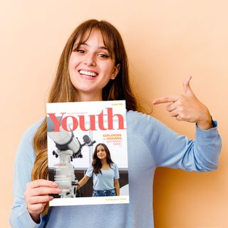 Youth holding the October 2022 Youth Magazine