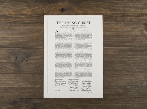 “The Living Christ” document on wooden background