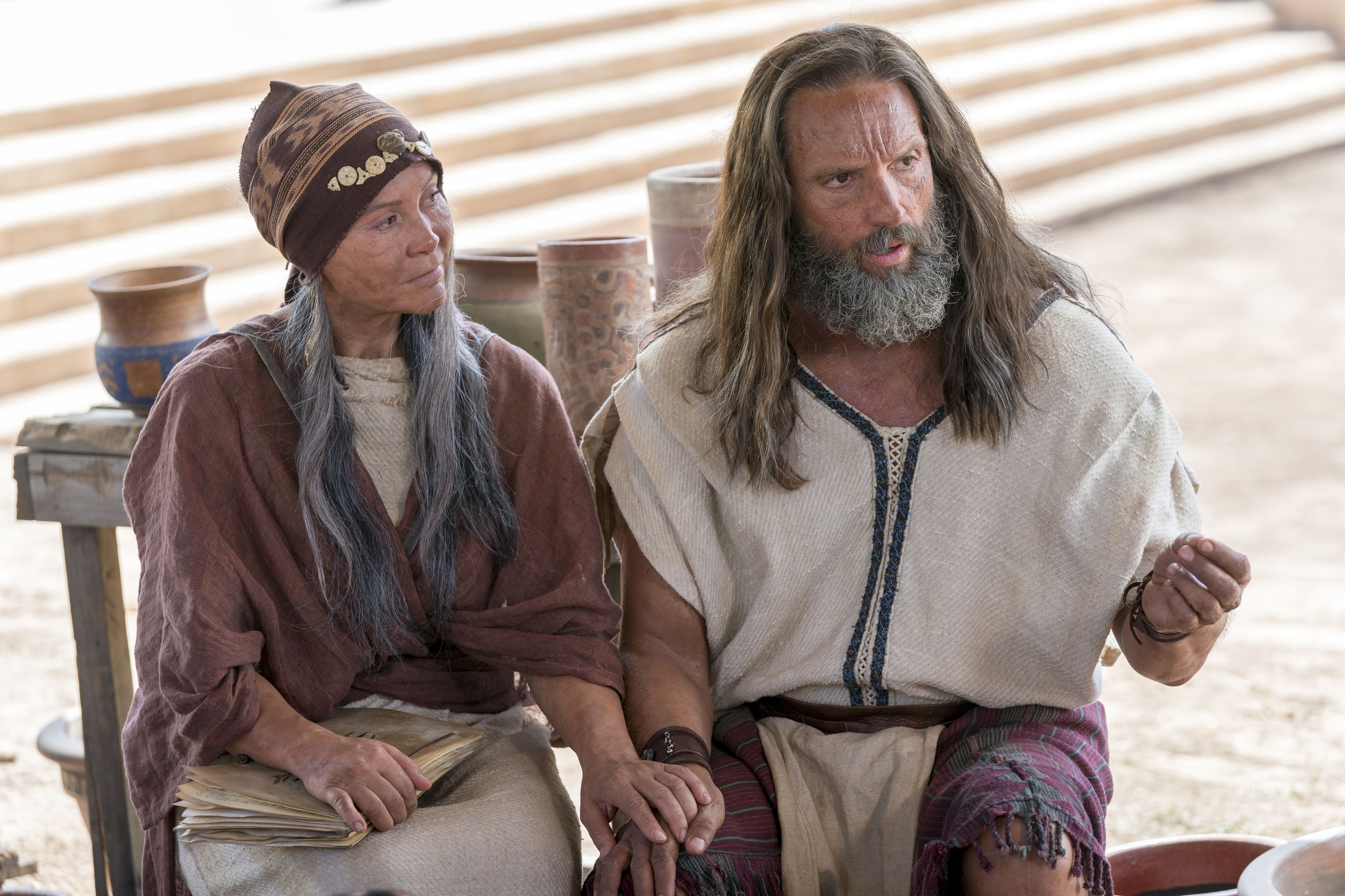 Nephi sits by his wife as he teaches the people about baptism and the doctrine of Christ.