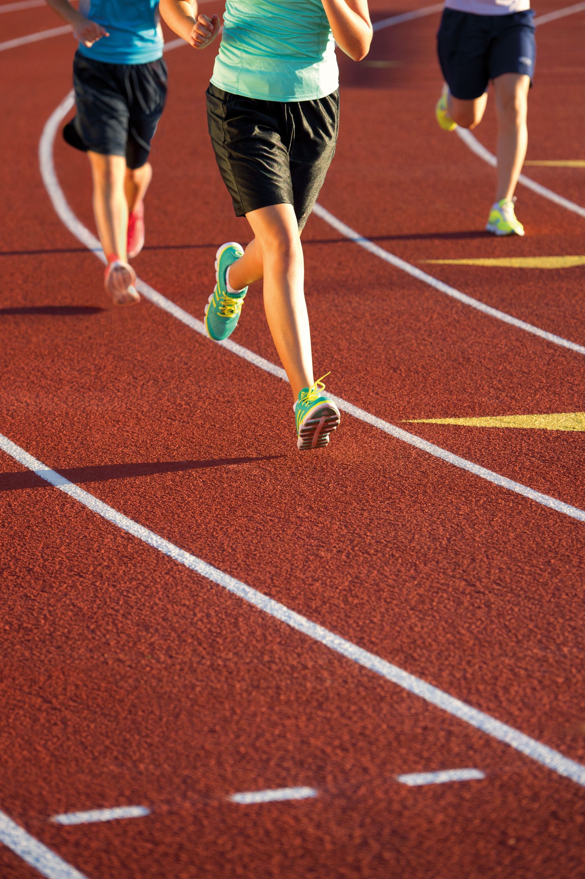 Runners race on a track.