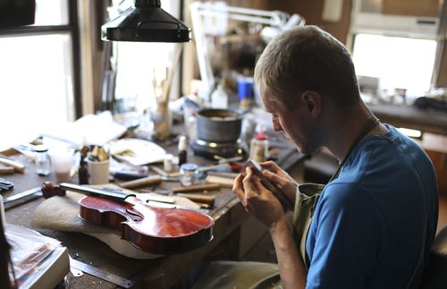 violin maker in workshop