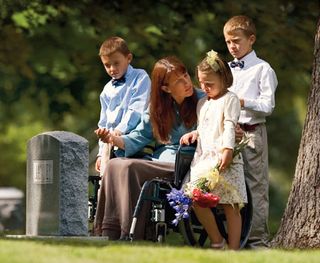 mother with children by gravestone