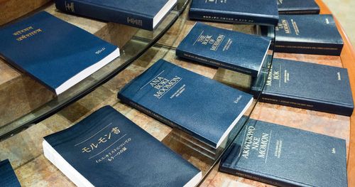 Copies of the Book of Mormon in many languages displayed in a visitors’ center.