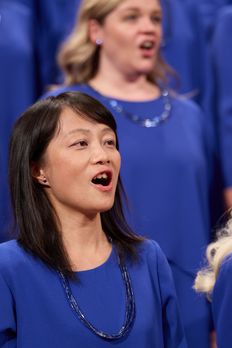 Members of the Tabernacle Choir sing during a session of general conference. A member of the global choir participants is singing with the choir. April 1-2, 2023.