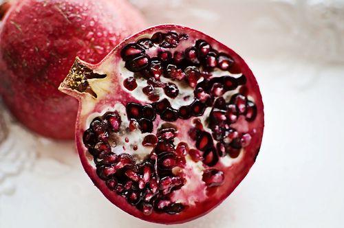 An image of a pomegranate sliced in half.