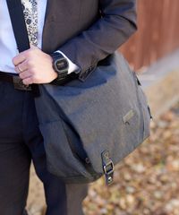 A missionary models appropriate dress and attire. He is wearing an approved wristwatch and book bag.