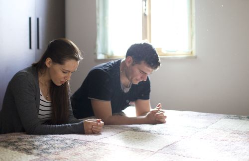 man and woman praying