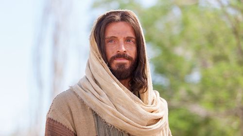 An actor portraying Jesus Christ is standing and looking forward.