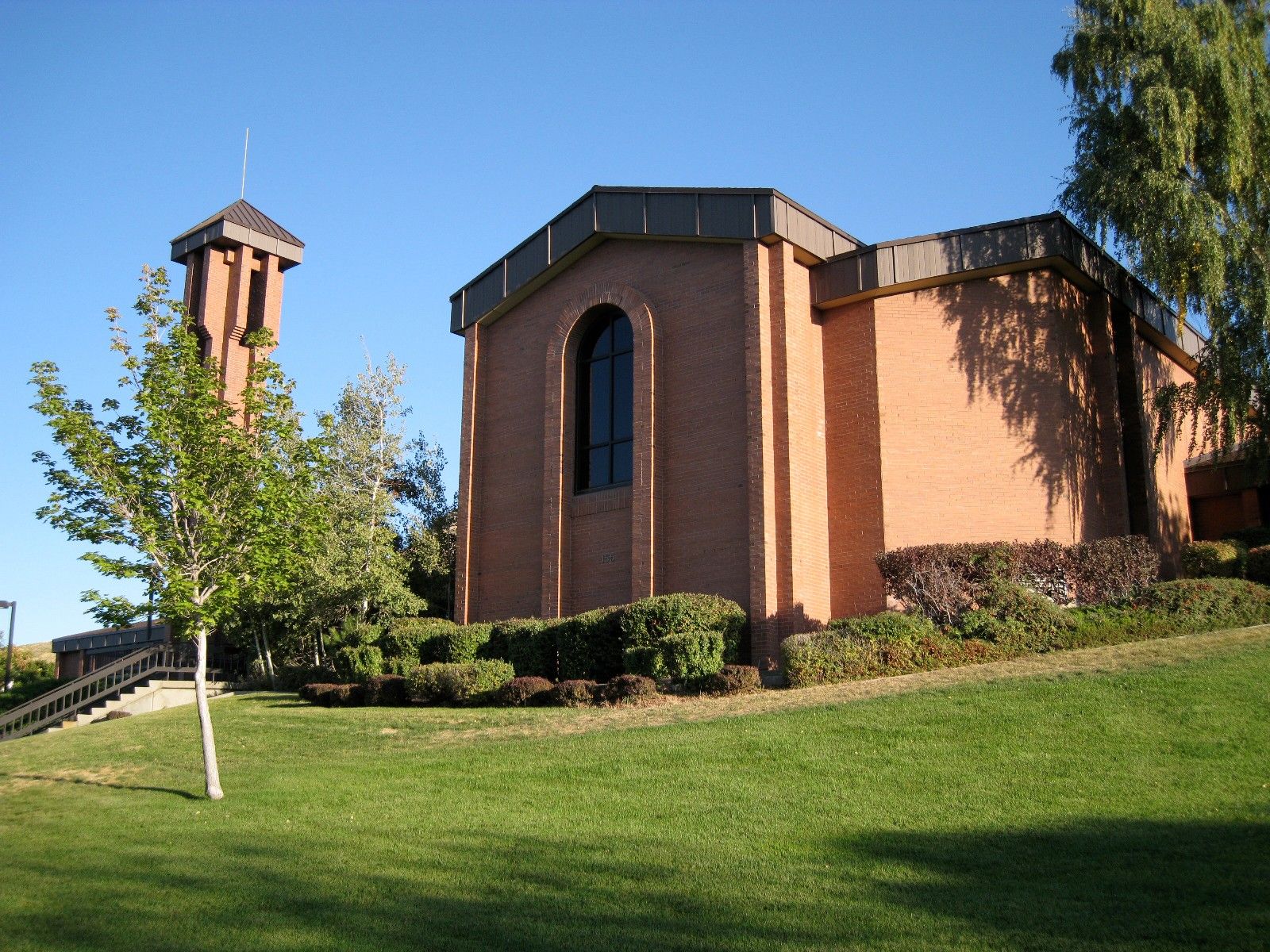 A chapel in Salt Lake City, Utah, on a grass hill.  