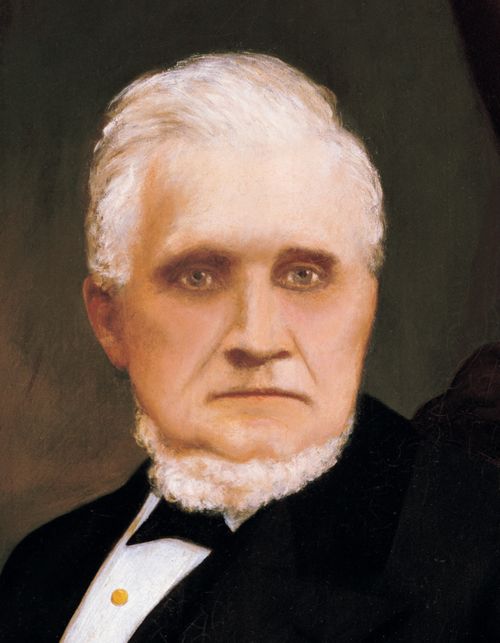 A painted portrait of John Taylor in a black suit, by A. Westwood.