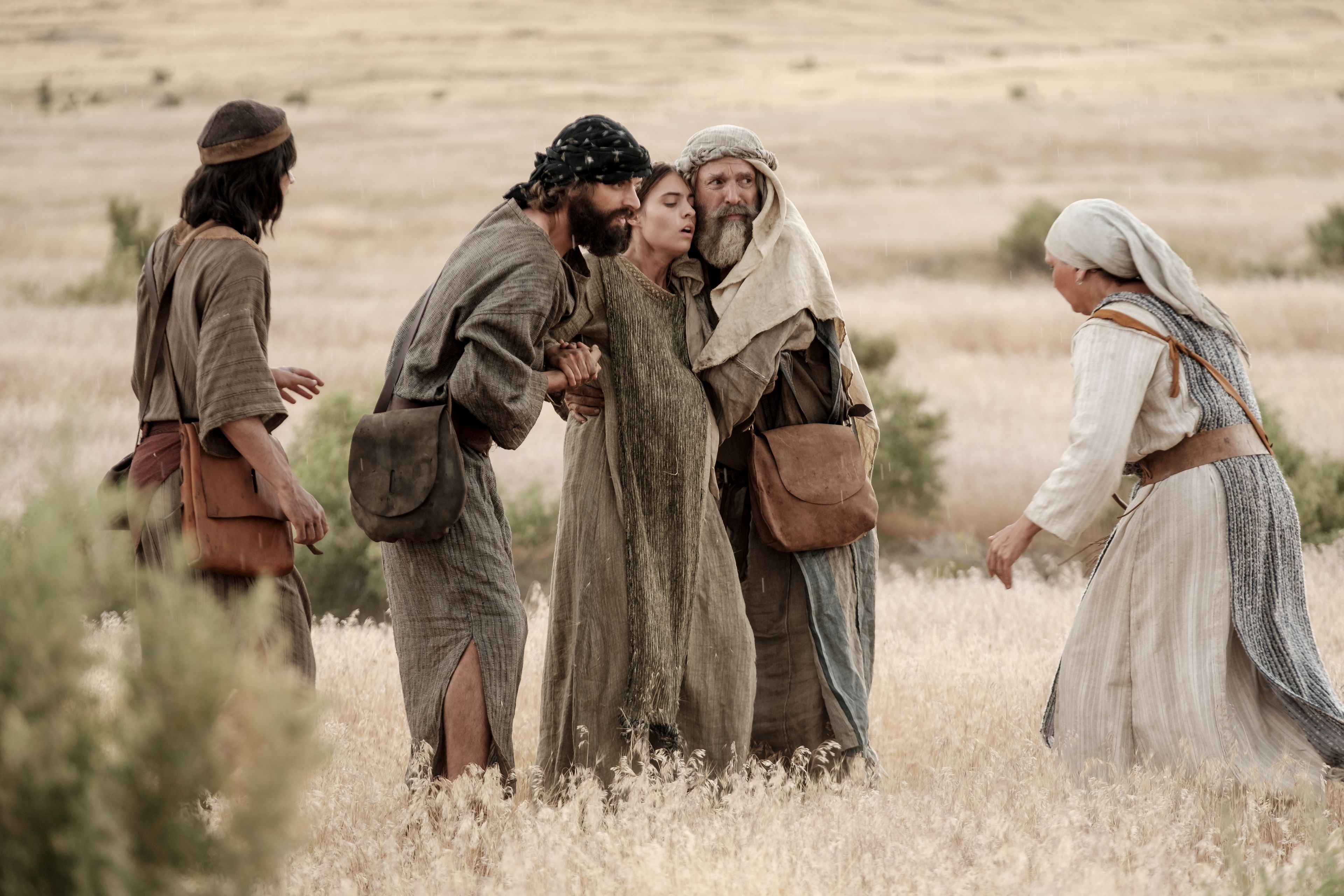 Lehi and one of Ishmael's sons help one of Ishmael's daughters in the wilderness.