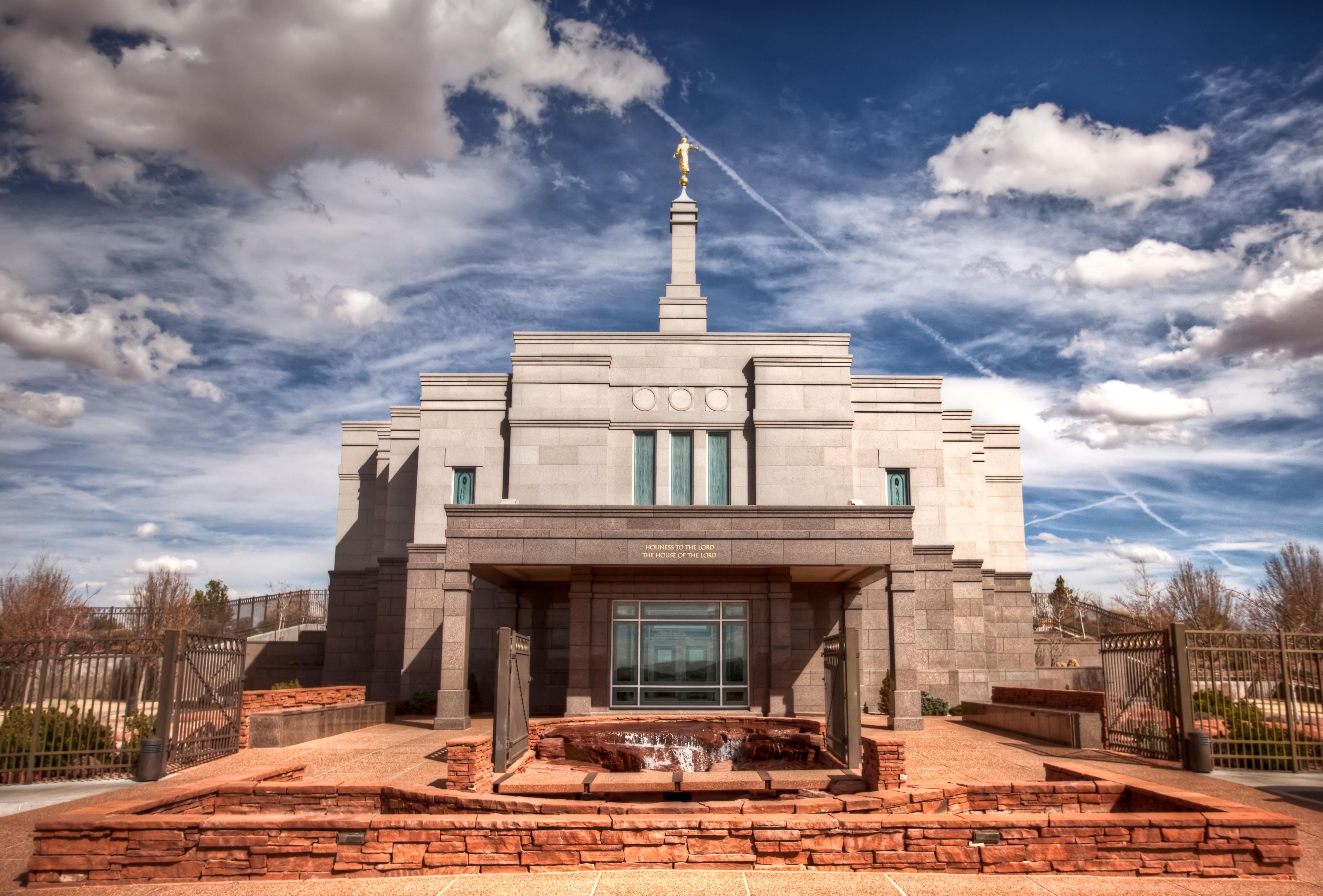 The Snowflake Arizona Temple and its entrance, with large white clouds overhead.