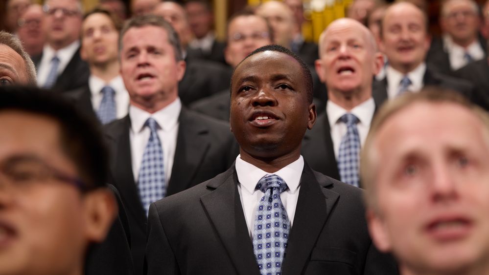 Members of the Tabernacle Choir sing during a session of general conference. A member of the global choir participants is singing with the choir. April 1-2, 2023.