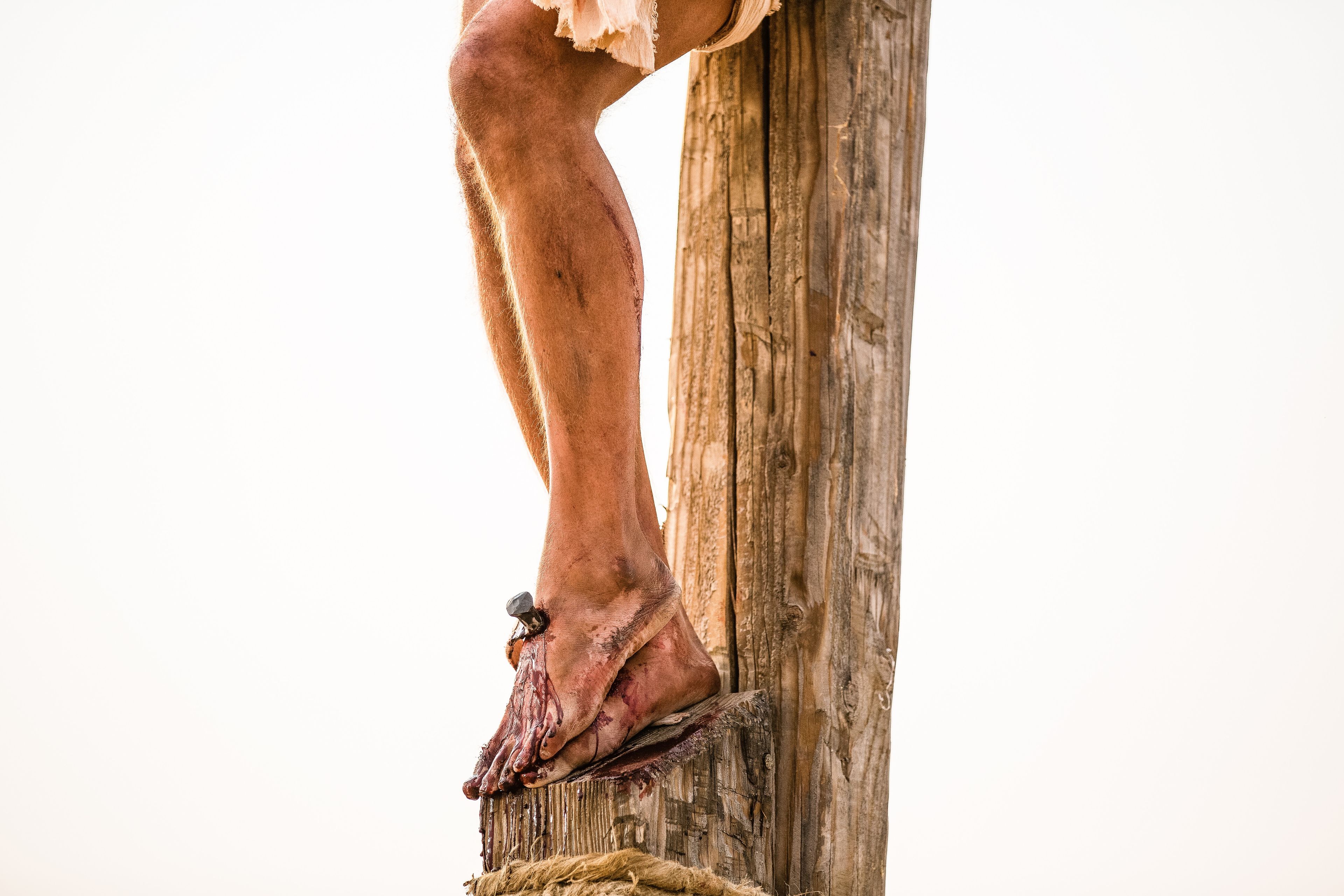 A detail of Christ’s feet nailed to the cross.