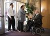 Man in wheelchair greeting others at church