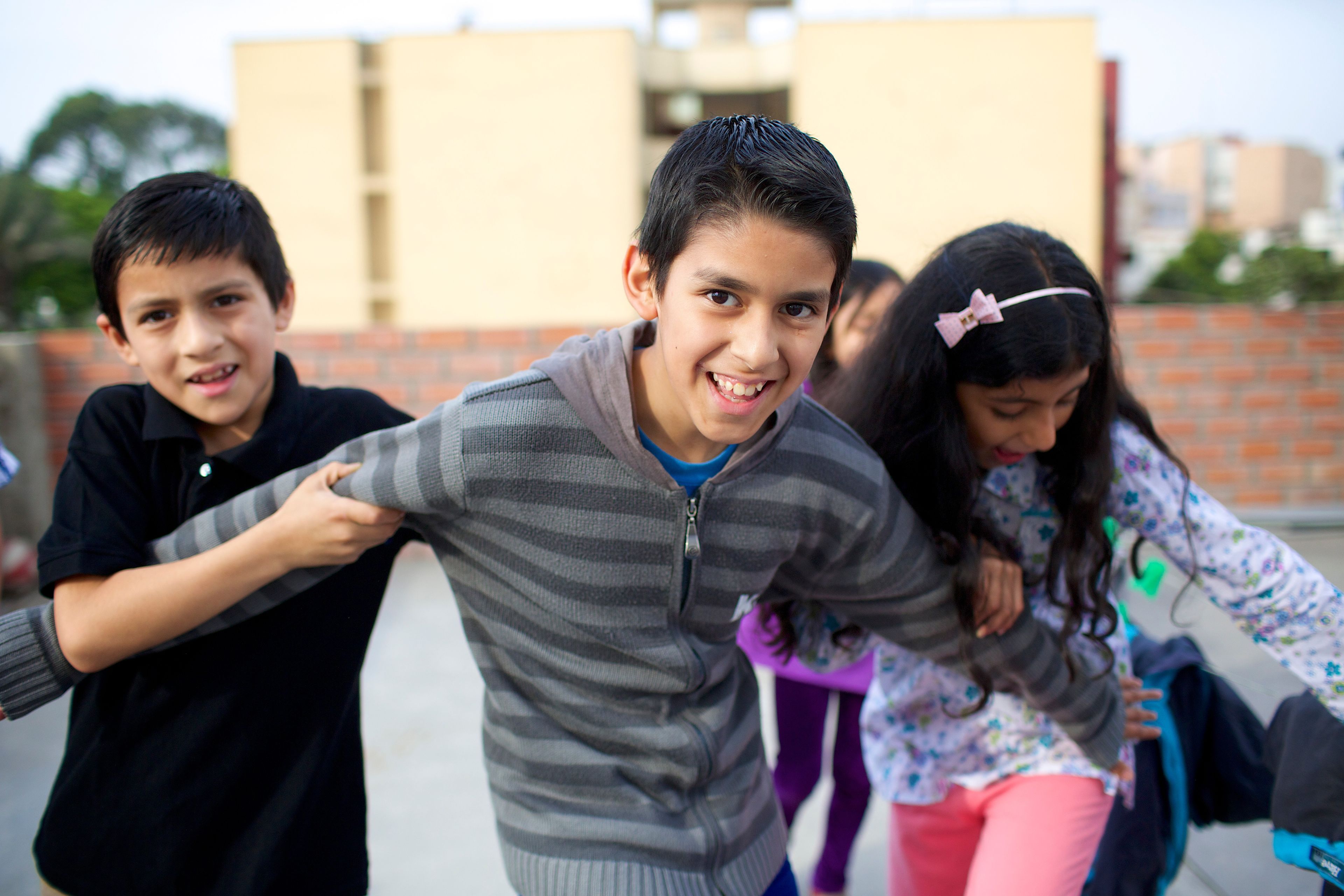 Peruvian children play together outside.  