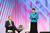Elder David A. Bednar and Sister Susan Bednar stand in front of an audience and talk with them in the Salt Palace during RootsTech 2019 in Salt Lake City, Utah.