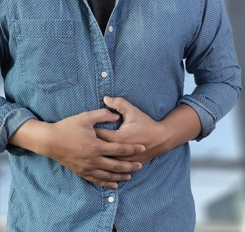 person holding injured stomach