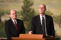 Elder Quentin L. Cook looks on as President Henry B. Eyring speaks to members of the press about Elder Cook's recent call to the apostleship.