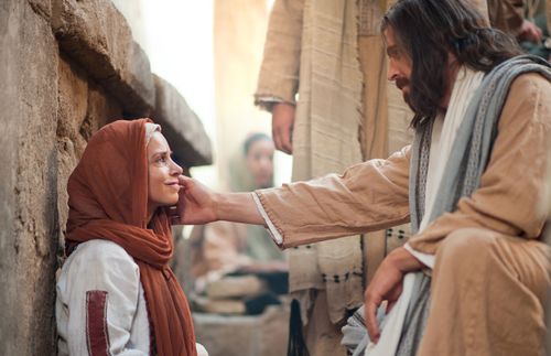Jesus Christ reaching His hand out to a woman