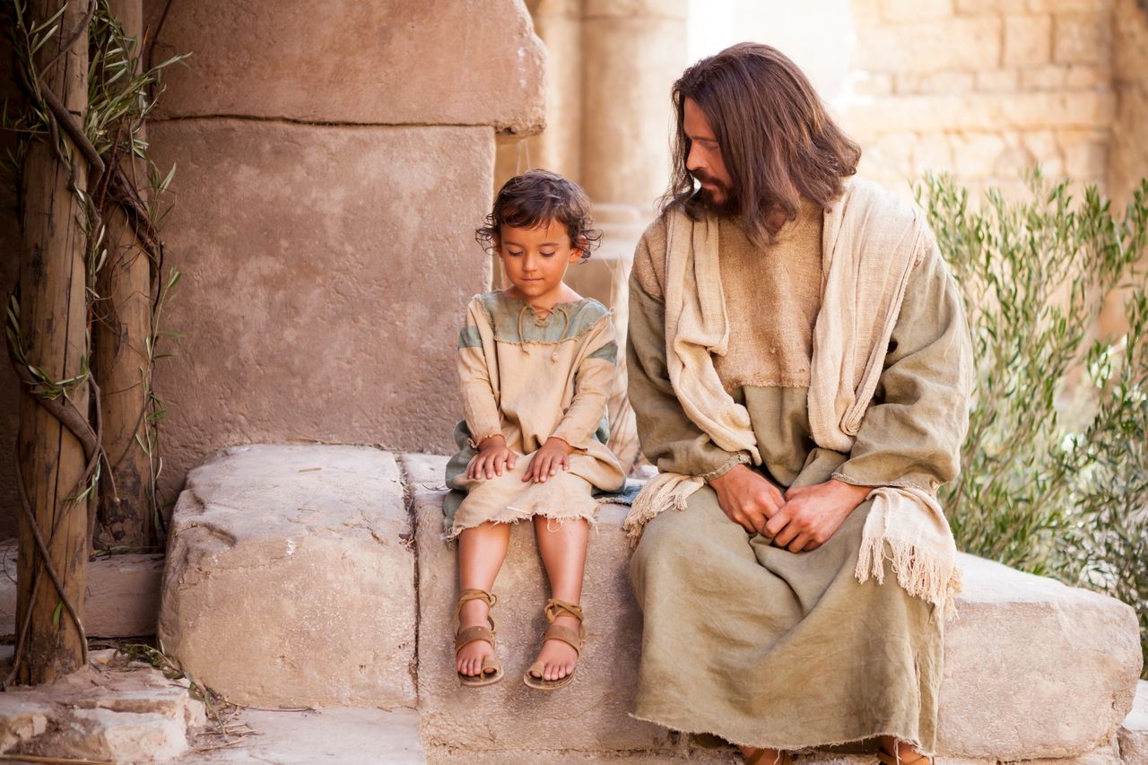 Jesus sitting next to little boy