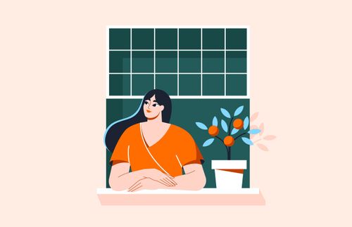 a woman standing and looking out her window