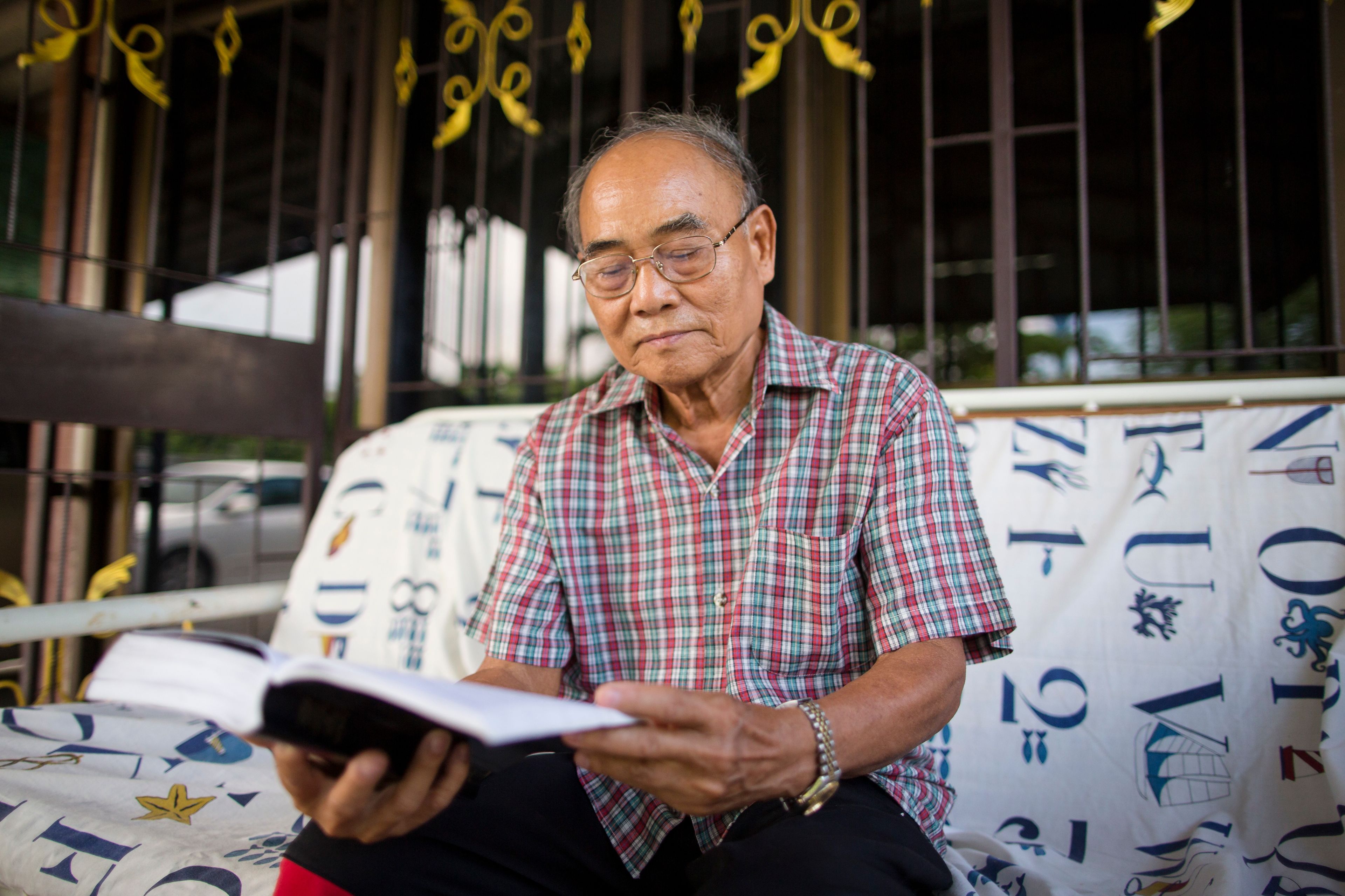 men in Thailand read scriptures and church magazines.