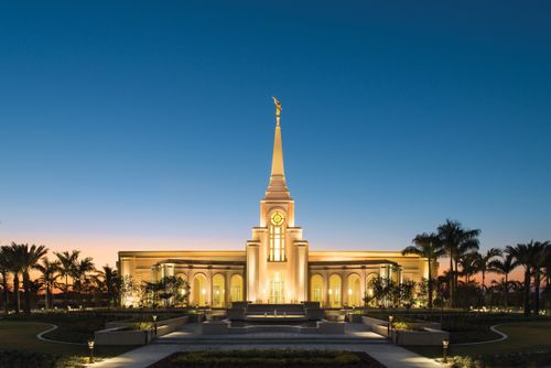 The front of the Fort Lauderdale Florida Temple lit up from without and within, just after sunset.