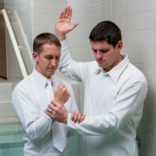 man baptizing another man