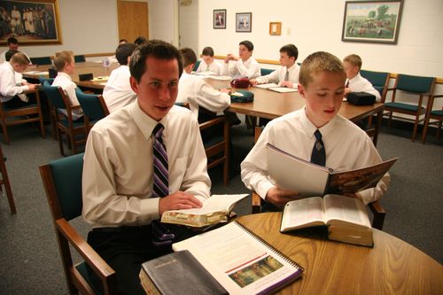 young men studying scriptures