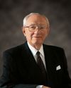 Frontal half-length portrait of President Gordon B. Hinckley. President Hinckley's hands are resting on the back of a chair. The image is the official Church portrait of President Hinckley as of 1995.  This was President Hinckley's last official portrait.  President Hinckley died 27 January 2008.