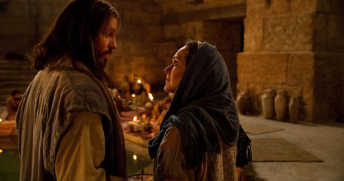 Jesus talking to Mary at a wedding feast.