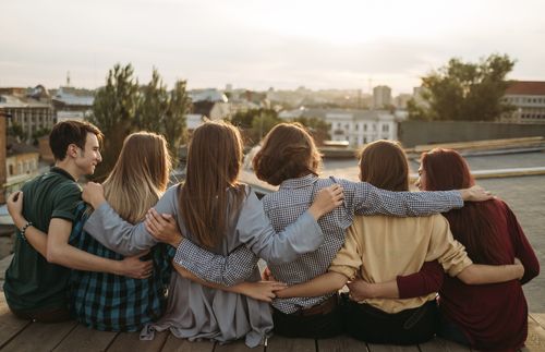 group of young people with arms around one another