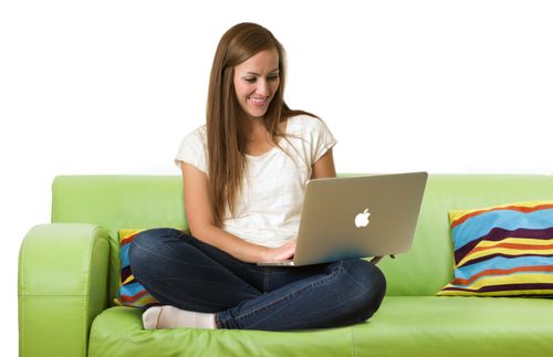 young adult woman with laptop on couch