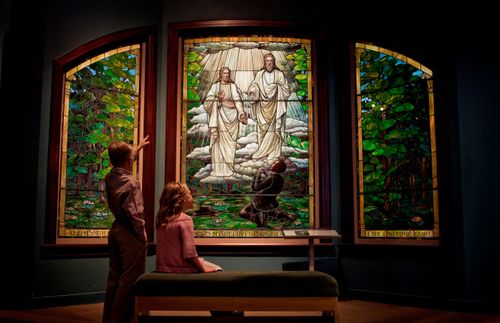 two children looking at an image of Jesus Christ and Heavenly Father